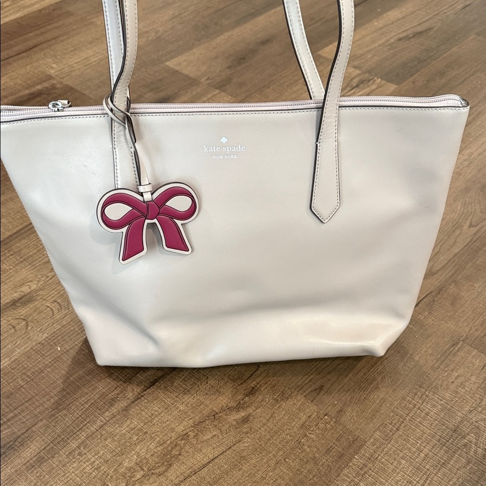 kate spade gray leather tote with pink bow charm pendant